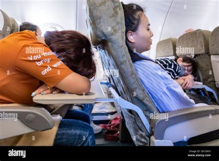 Do flight attendants wake up sleeping passengers?