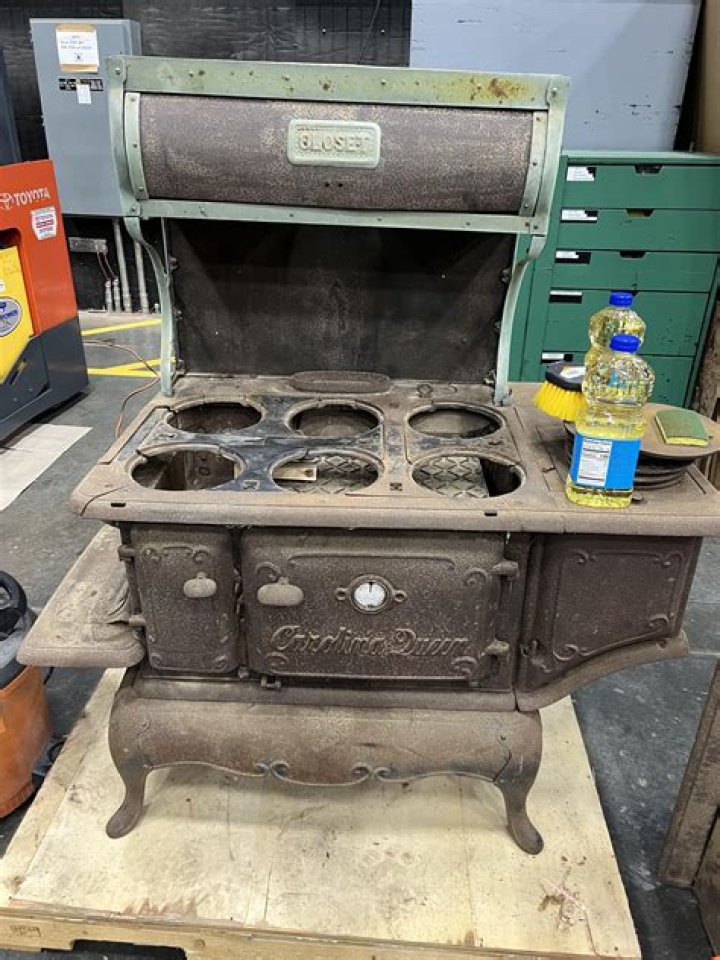 How do you clean the top of a cast iron stove?