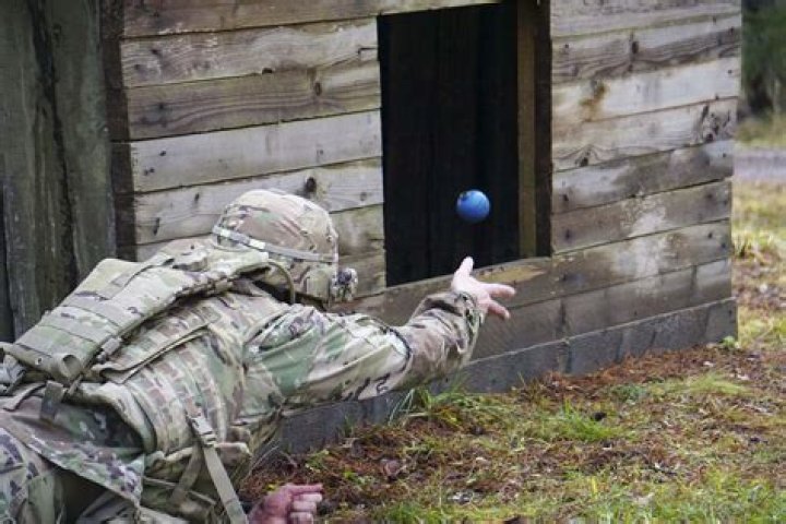 How far can a soldier throw a grenade?