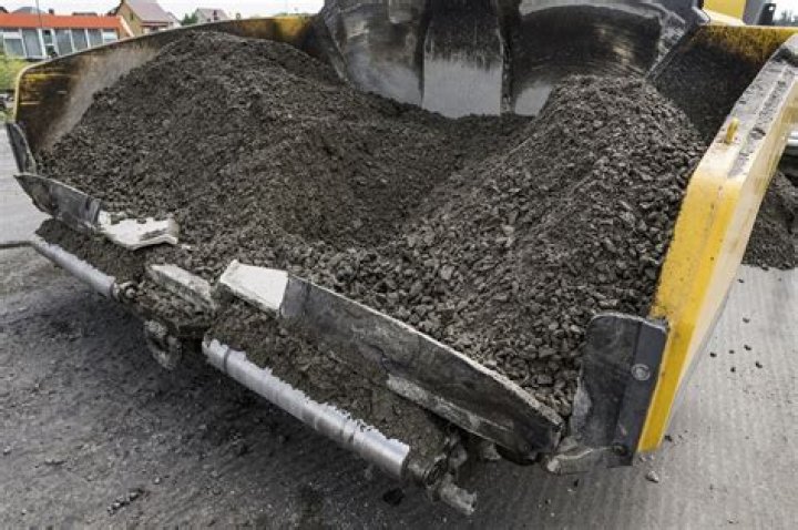 Why do they put sand on new asphalt?