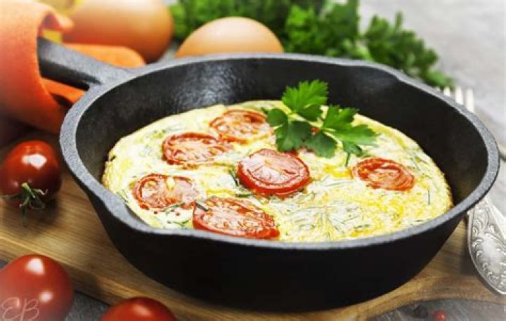 Why should a cast iron skillet be used for scrambled eggs?
